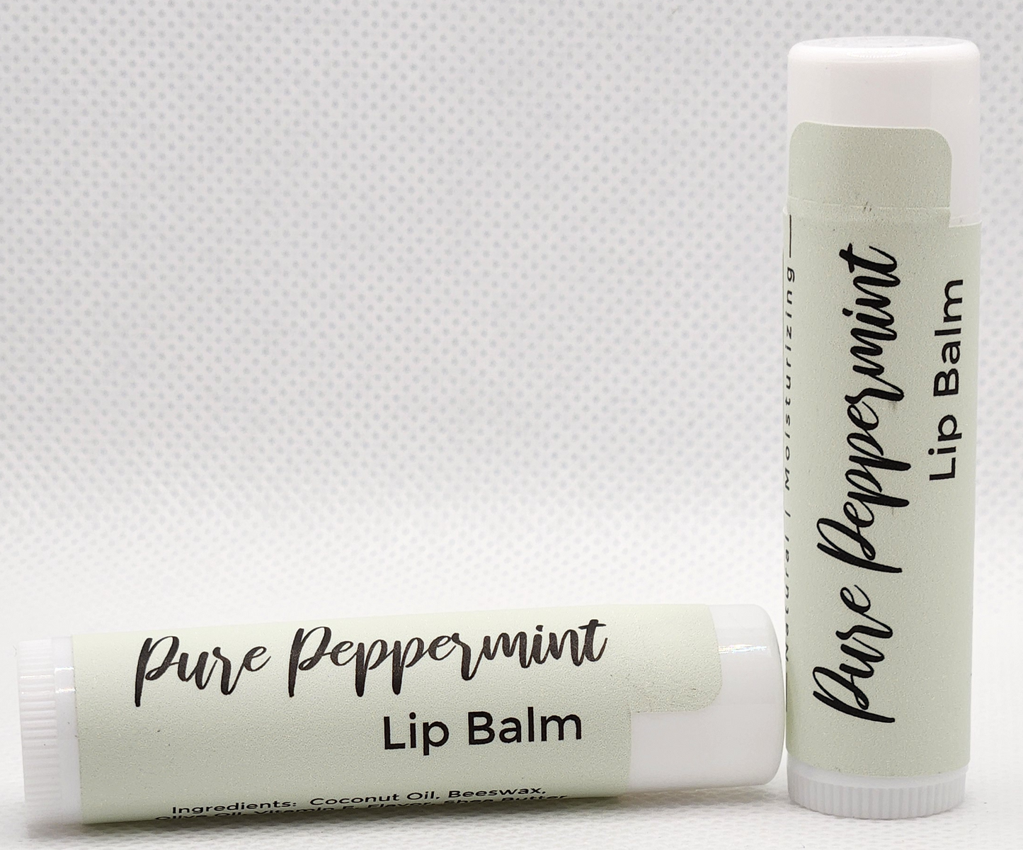 A sleek, eco-friendly tube of pure peppermint lip balm, with a minimalist design and clear labeling. The tube is a light, natural color with the product name displayed in elegant, clean fonts.