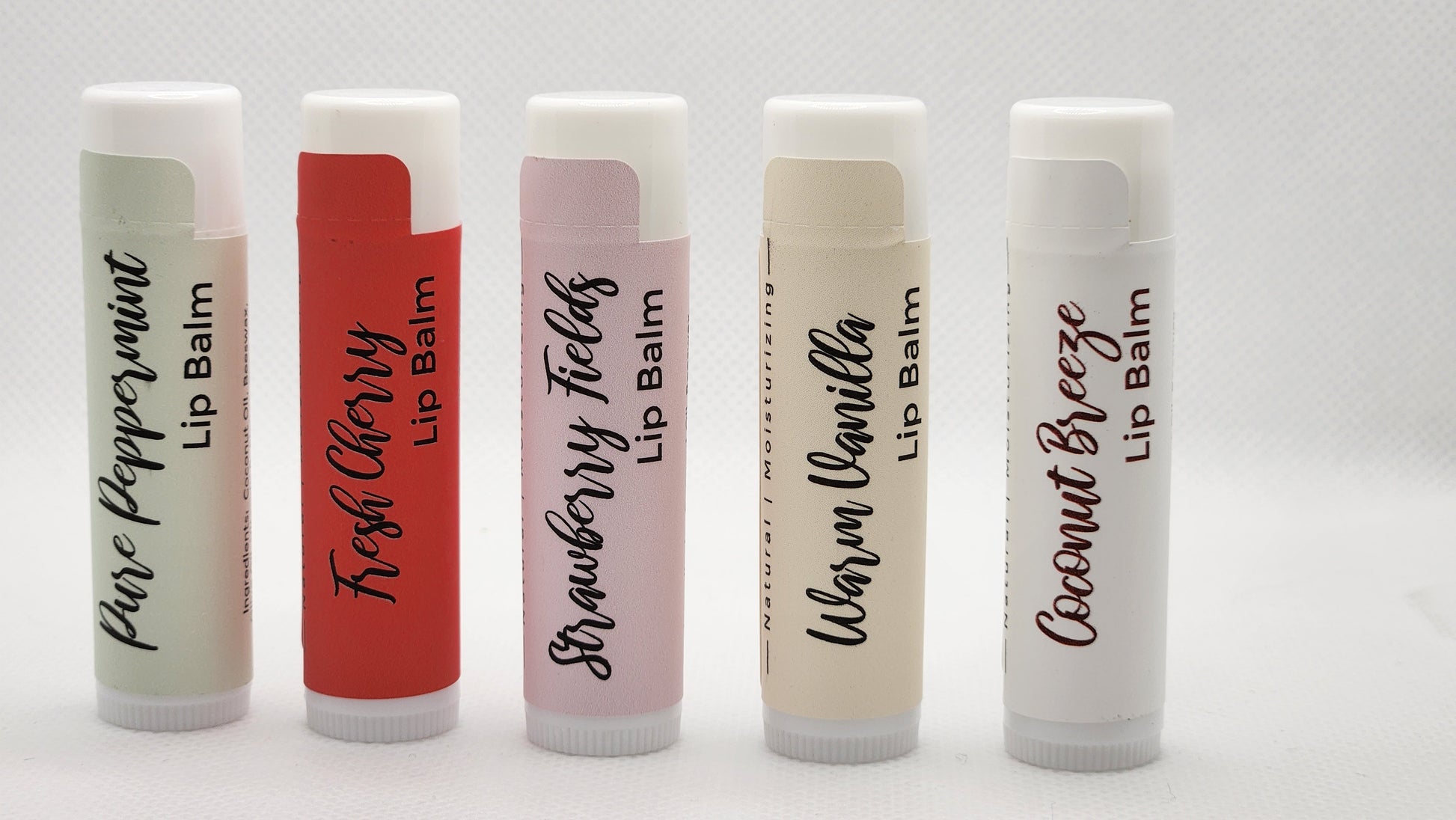 A sleek, eco-friendly tubes of lip balm, with a minimalist design and clear labeling. The tube is a light, natural color with the product name displayed in elegant, clean fonts.