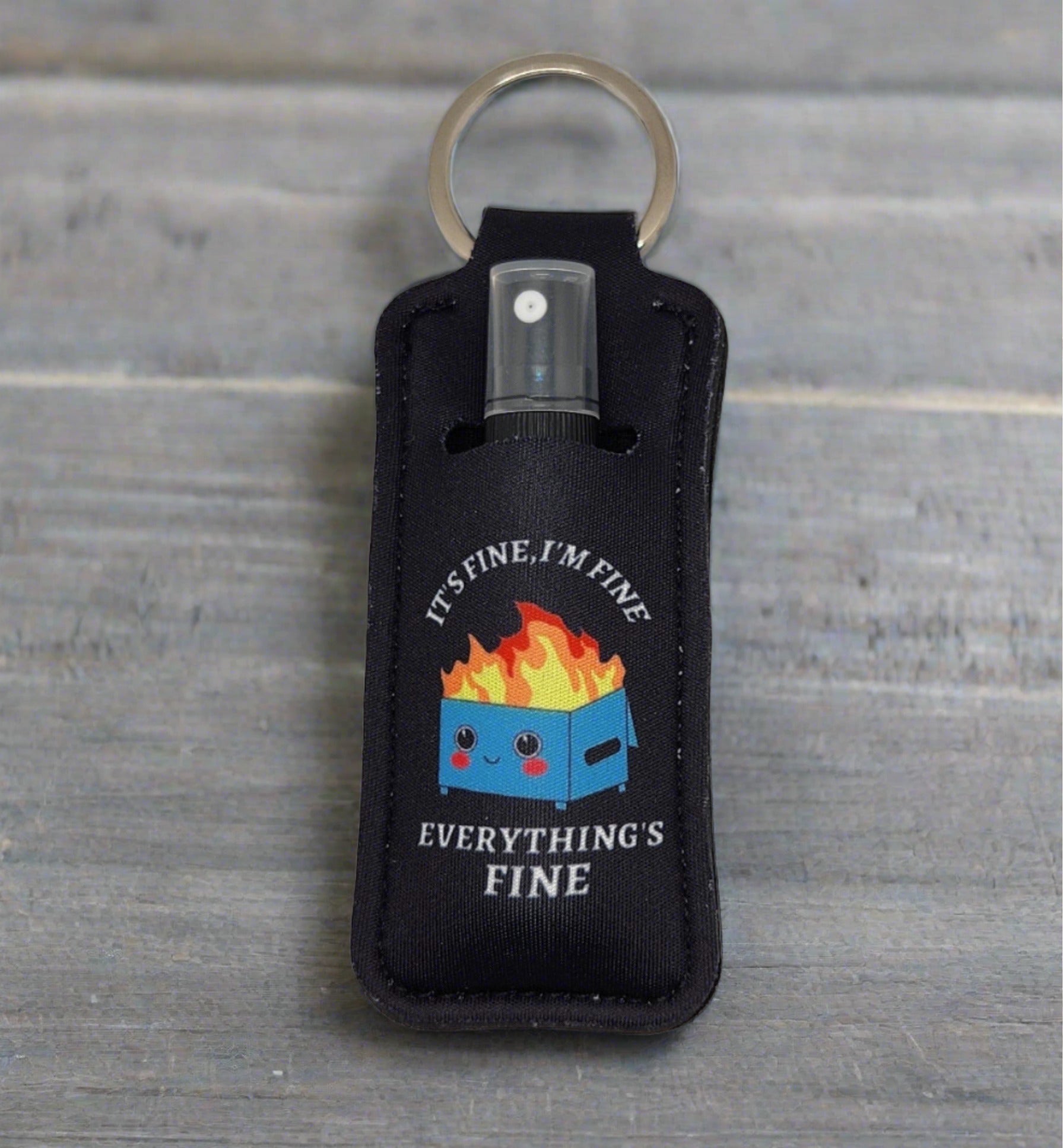 Showcasing magnesium spray on the go in a black keychain holder.  